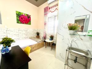 a small room with a bed and a sink at LaMera Hotel Homestay in Ben Tre +60 photos