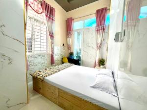 a bedroom with a bed and a window at LaMera Hotel Homestay in Ben Tre