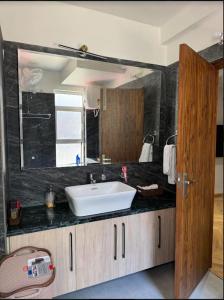 a bathroom with a sink and a mirror at Entire 4bhk villa in Panchkula, Chandigarh in Panchkula +22 photos