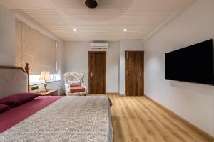 a bedroom with a bed and a flat screen tv at Entire 4bhk villa in Panchkula, Chandigarh in Panchkula