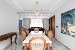 a dining room with a table and chairs and a chandelier at Entire 4bhk villa in Panchkula, Chandigarh in Panchkula