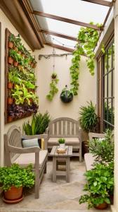 a patio with two chairs and a table and plants at LaMera Hotel Homestay in Ben Tre