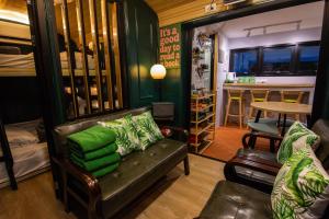 a living room with a couch and a bar at Baan Rot Fai Krabi Platform 2 in Ao Nam Mao