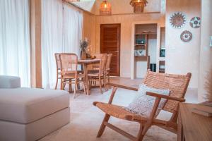 a living room with chairs and a table and a couch at SeaTara Resort in Ko Phangan