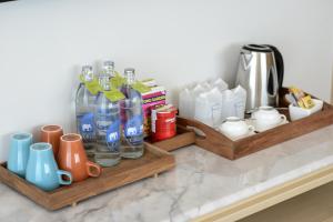 two wooden shelves with bottles and cups on a counter at Hisea Huahin Hotel in Hua Hin
