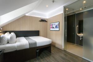 a hotel room with a bed and a bathroom at The Z Hotel Victoria in London