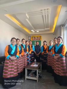 a group of women sitting on chairs in a room at Little Buddha Inn in Kathmandu