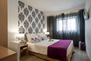 Postel nebo postele na pokoji v ubytování Hotel Genesis