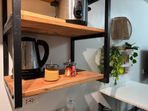 a shelf with a coffee pot and candles on it at Unit 26 SeaView Studio in Dumaguete +29 photos