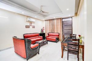 a waiting room with red chairs and a desk at FabHotel Sarala Residency in Noida