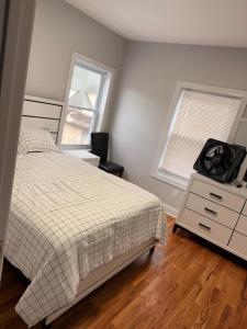 a bedroom with a bed and a dresser and a window at The great homes in East Orange