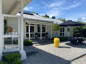a house with a yellow vase and an umbrella at Resort Arrowtown in Arrowtown