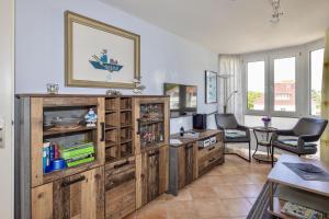 a living room with a large wooden entertainment center at Fewo Meeresleuchten - Strandkorb auf Balkon, TG in Baabe