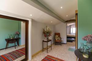 a room with a mirror and a table with vases on it at Mas des Côtes in Saint-Hippolyte-le-Graveyron