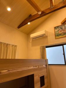 a small room with a window and a air conditioner at shine house warabi2 in Warabi