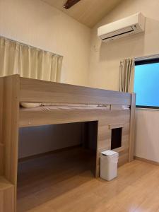 a bunk bed in a room with a desk at shine house warabi2 in Warabi