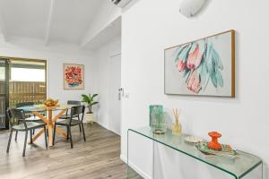 a dining room with a glass table and a dining at Hidden Gem - 3BR Home - Cairns in Edge Hill