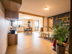 a kitchen and living room with a table and chairs at Appartement Spa VIP du Pont Alsort 2-3 in Froid-Chapelle