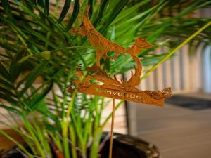 a wooden figurine of a bird on a stick at Appartement Spa VIP du Pont Alsort 2-3 in Froid-Chapelle +21 photos