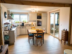 a kitchen with a table and chairs in a room at Appartement Spa VIP du Pont Alsort 2-3 in Froid-Chapelle