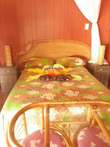 a bed with a bedspread with flip flops on it at MONITA VILLA Rangiroa in Tiputa