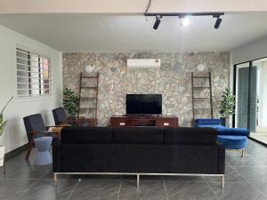 a living room with a couch and a tv at Sanyan Retreat in Jeram