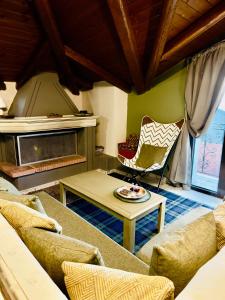 a living room with a couch and a chair at Pandoras House Arachova in Arachova