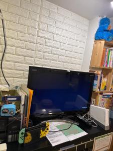 a computer monitor sitting on top of a desk at Peace House Showa in Osaka