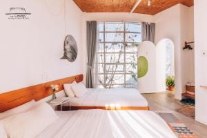 a bedroom with two beds and a window at The LOOP Boutique Hotel & Café in Da Lat +120 photos