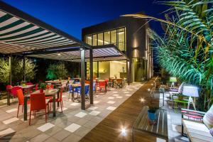 a restaurant with tables and chairs on a patio at Proimos Maisonnettes in Plataniás