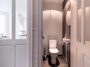 a bathroom with a toilet and a sink at Scenic villa in Borgloon with garden in Borgloon +32 photos