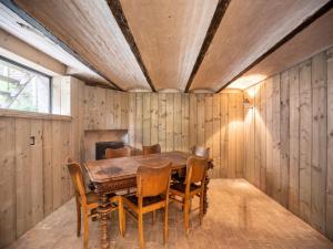 a dining room with a wooden table and chairs at Scenic villa in Borgloon with garden in Borgloon