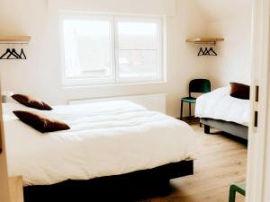 a bedroom with two beds and a window at Luxury Holiday Home in Wingene for 12 in Wingene