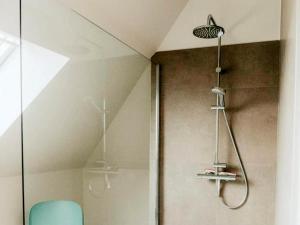 a shower in a bathroom with a blue chair at Luxury Holiday Home in Wingene for 12 in Wingene +33 photos