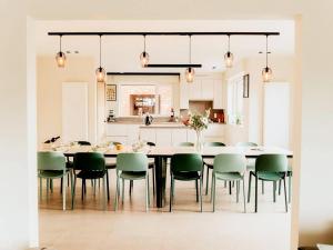 a kitchen and dining room with a large table and chairs at Luxury Holiday Home in Wingene for 12 in Wingene