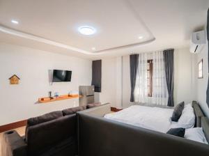 a living room with a couch and a bed at Villanin Hotel & Spa Golden Triangle in Ban Wiang Nuea +23 photos