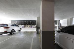 two cars are parked in a parking garage at Hotel Yam Bucheon Station in Bucheon