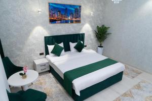 a bedroom with a bed and a table and a chair at Afruza Hotel in Samarkand +13 photos