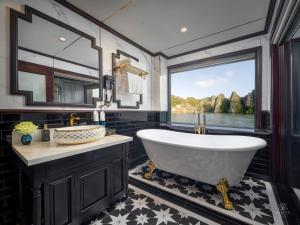 a bathroom with a tub and a large window at AIME'E CRUISES - Halong Bay in Ha Long +62 photos