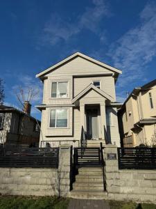 a white house with stairs in front of it at Comfort 2 BR Vancouver! in Vancouver