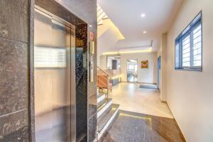 a hallway of a house with a glass door at FabHotel Ayodhya in Pune