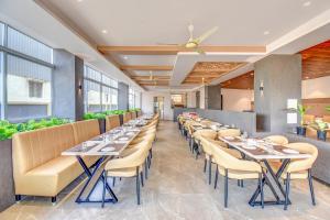 a row of tables and chairs in a restaurant at FabHotel Ayodhya in Pune +40 photos