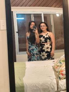 two women taking a picture of themselves in a mirror at Ronika devi in Savu
