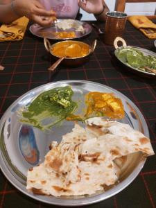 a plate of food on a table with food at Ronika devi in Savu