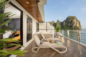 a balcony with a chair and a table at AIME'E CRUISES - Halong Bay in Ha Long