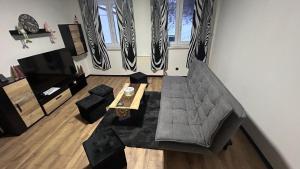 a living room with a couch and a table at Haus Vranjes in Rosenau am Hengstpass