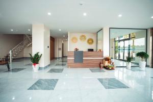 a lobby with a reception desk in a building at EcoHouse Boutique Hotel Huế in Hue +54 photos