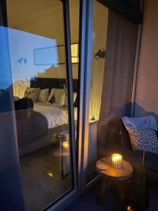 a room with a bed and a table and a window at Schöne Aussicht - charmante Ferienwohnung mit Pool und Sauna in Bad Harzburg in Bad Harzburg +36 photos