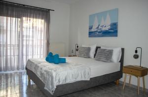 a bedroom with a bed with blue blocks on it at Faros AXD Apartment in Alexandroupoli