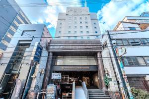 a building in the middle of a city at アメ村ガーデンホテルAmemura Garden Hotel in Osaka
